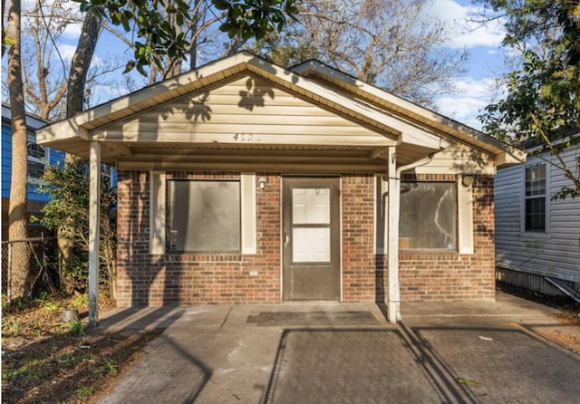 rear view of house with brick siding