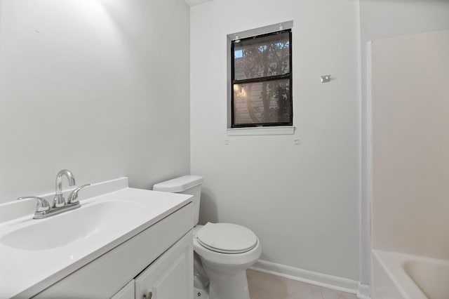 bathroom with toilet, a bathing tub, vanity, baseboards, and tile patterned floors