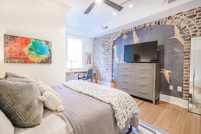 84 Bull St Unit F, Charleston, SC 29401 - bedroom featuring wood finished floors, crown molding, ceiling fan, baseboards, and an accent wall