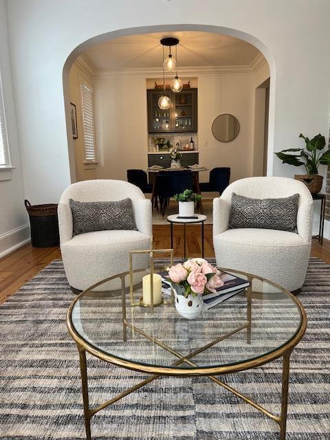 84 Bull St Unit F, Charleston, SC 29401 - living area featuring arched walkways, wood finished floors, baseboards, and ornamental molding