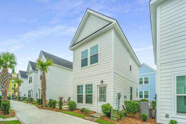 rear view of property featuring central AC unit