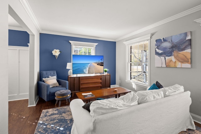 living room with dark hardwood / wood-style floors, plenty of natural light, and ornamental molding