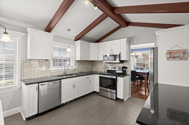 kitchen with sink, white cabinets, pendant lighting, and appliances with stainless steel finishes