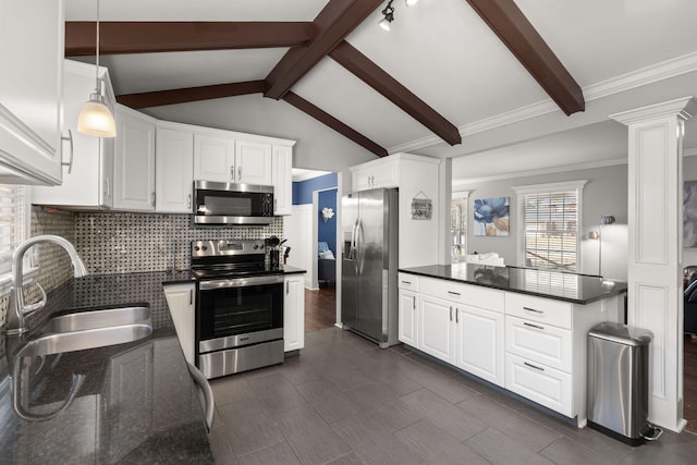 kitchen with white cabinetry, sink, stainless steel appliances, vaulted ceiling with beams, and decorative columns