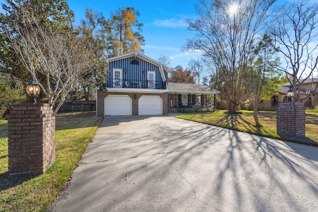 view of front of home with a balcony, a front yard, and a garage