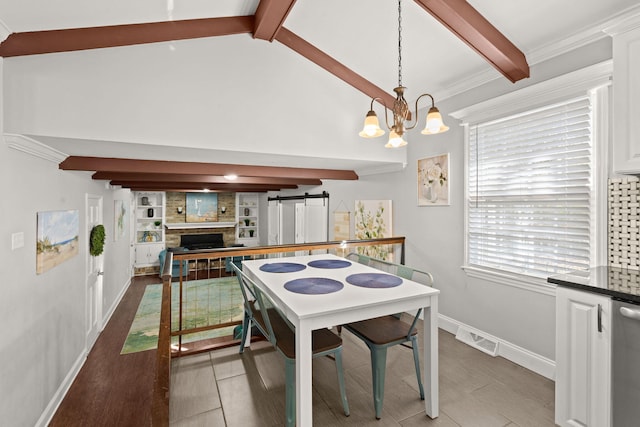 dining space featuring ornamental molding, a barn door, lofted ceiling with beams, a chandelier, and hardwood / wood-style floors