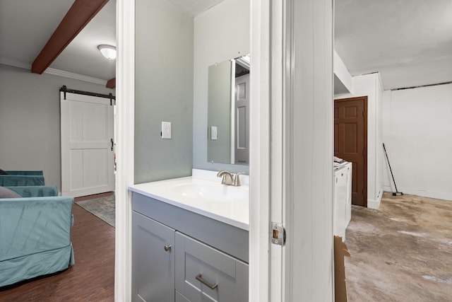 bathroom featuring hardwood / wood-style flooring, beamed ceiling, vanity, and ornamental molding