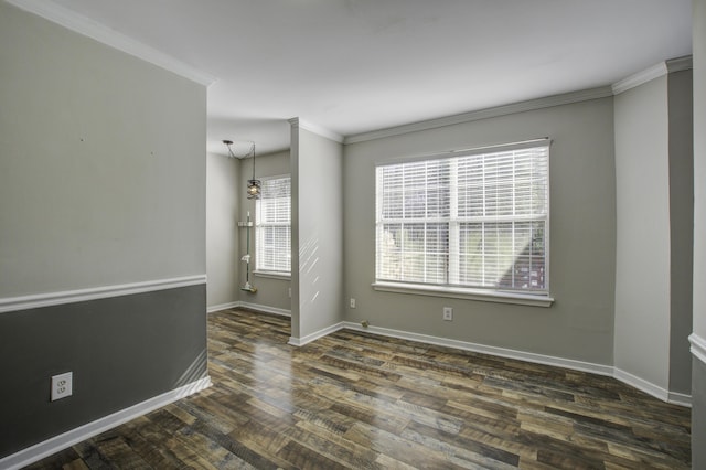 empty room featuring baseboards, dark wood finished floors, and crown molding