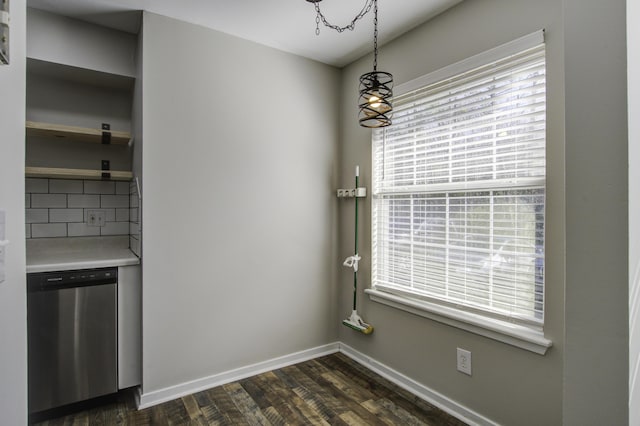 unfurnished dining area with baseboards and dark wood-type flooring