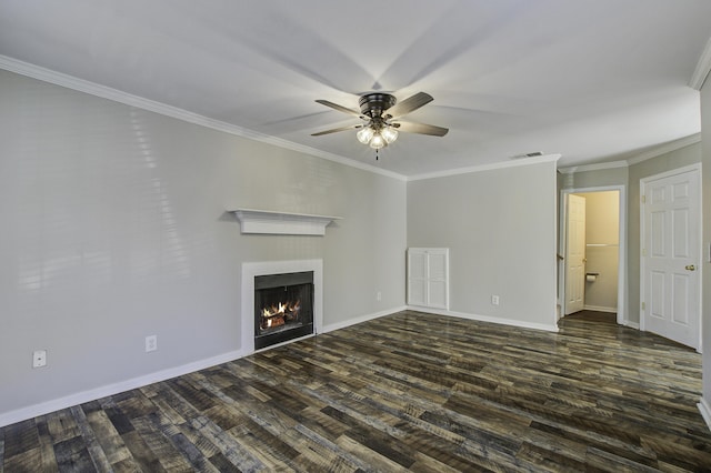 unfurnished living room featuring ornamental molding, dark wood-style floors, visible vents, and a lit fireplace