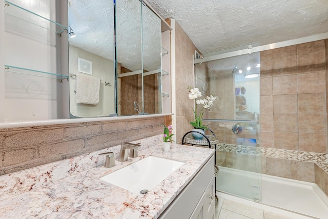 2506 Birkenhead Dr, Charleston, SC 29414 - full bath with tile patterned floors, vanity, a textured ceiling, and a shower stall