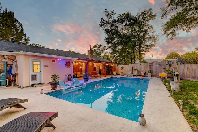 2506 Birkenhead Dr, Charleston, SC 29414 - pool at dusk with a fenced backyard, a patio area, and a fenced in pool