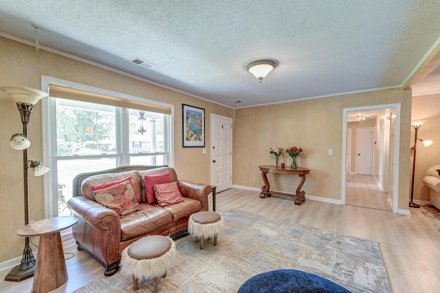 2506 Birkenhead Dr, Charleston, SC 29414 - living room featuring crown molding, visible vents, a textured ceiling, and light wood finished floors