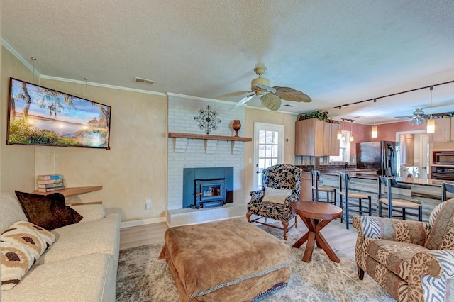 2506 Birkenhead Dr, Charleston, SC 29414 - living room featuring a ceiling fan, crown molding, a textured ceiling, light wood-style floors, and visible vents