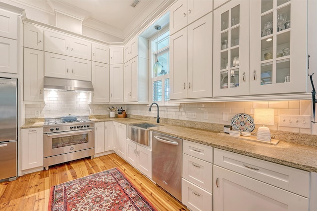 312 Hobcaw Dr, Mount Pleasant, SC 29464 - kitchen with stainless steel appliances, extractor fan, ornamental molding, a sink, and light wood-type flooring