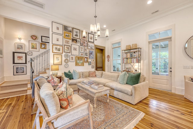 312 Hobcaw Dr, Mount Pleasant, SC 29464 - living room with stairway, ornamental molding, a chandelier, light wood-style flooring, and recessed lighting