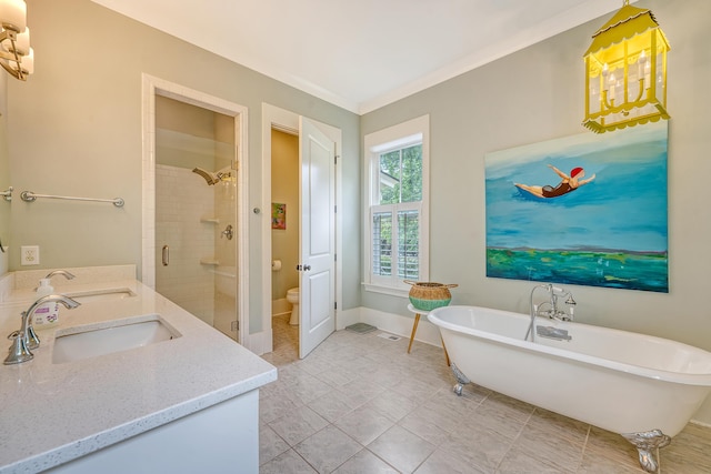 312 Hobcaw Dr, Mount Pleasant, SC 29464 - bathroom featuring a soaking tub, double vanity, a stall shower, toilet, and baseboards