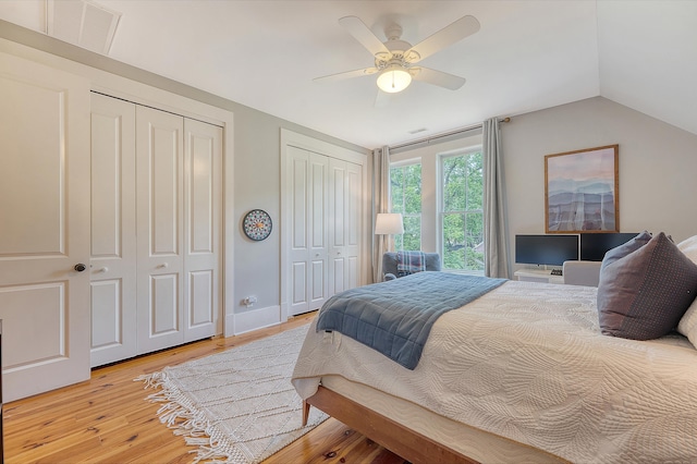 312 Hobcaw Dr, Mount Pleasant, SC 29464 - bedroom featuring multiple closets, light wood-type flooring, vaulted ceiling, and ceiling fan