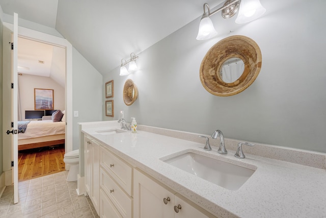 312 Hobcaw Dr, Mount Pleasant, SC 29464 - ensuite bathroom with lofted ceiling, double vanity, toilet, and tile patterned flooring