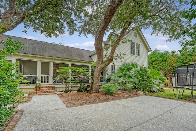 312 Hobcaw Dr, Mount Pleasant, SC 29464 - back of property with a trampoline, roof with shingles, and a sunroom