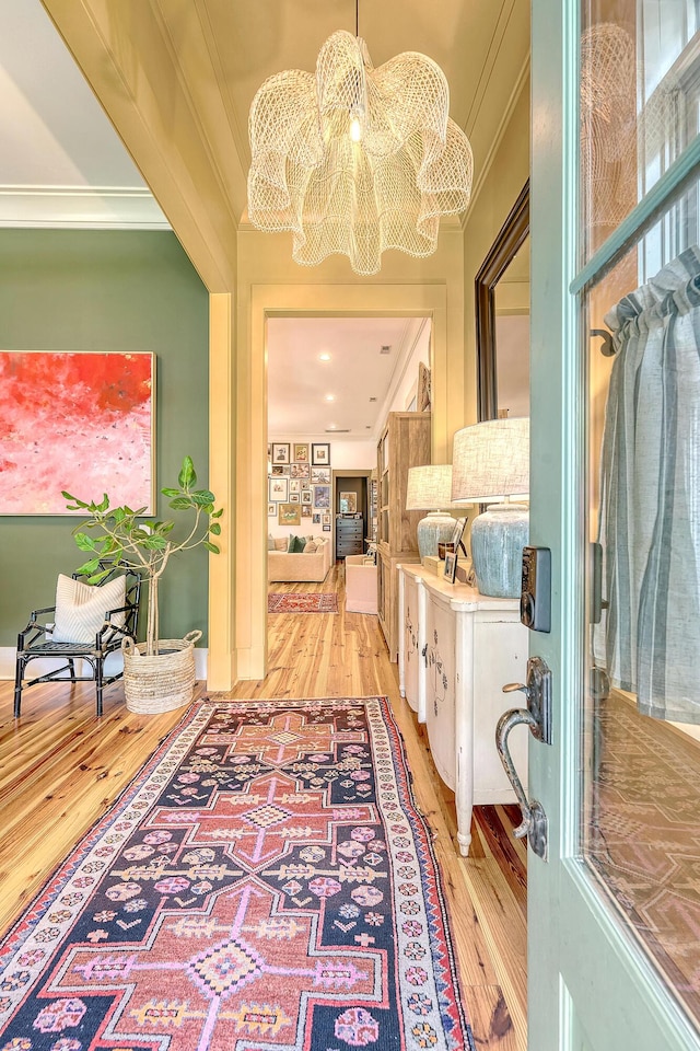 312 Hobcaw Dr, Mount Pleasant, SC 29464 - hallway with ornamental molding, a chandelier, and light wood-type flooring