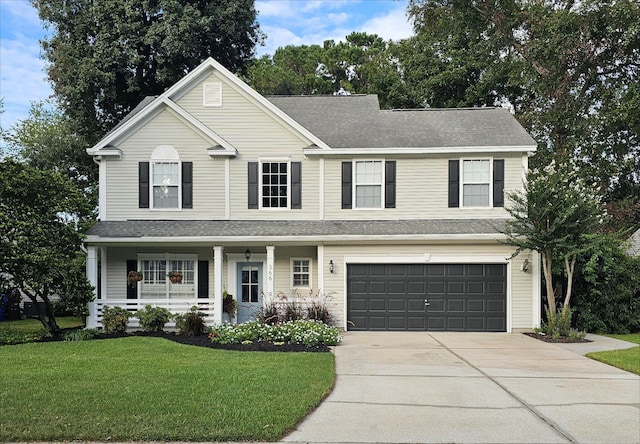 front facade featuring a front yard, a porch, and a garage