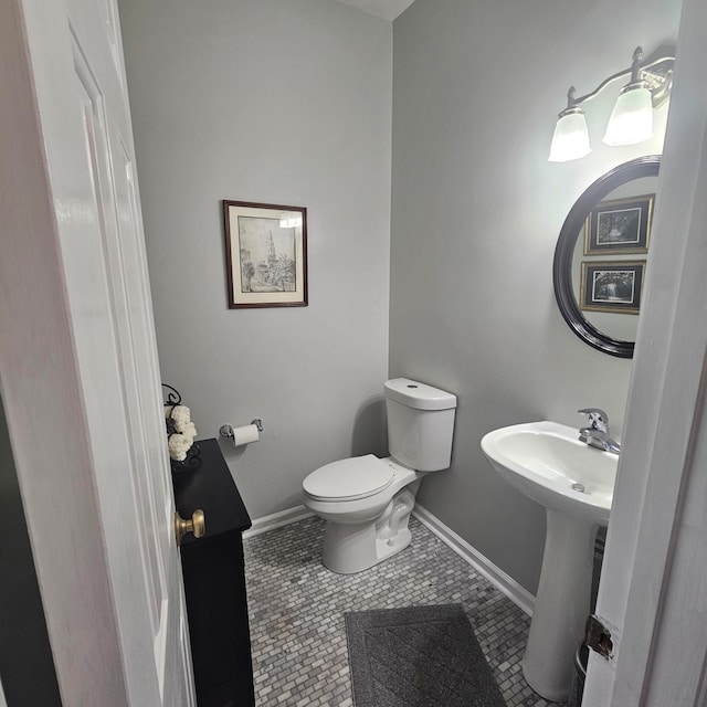 bathroom with sink, toilet, and tile patterned floors