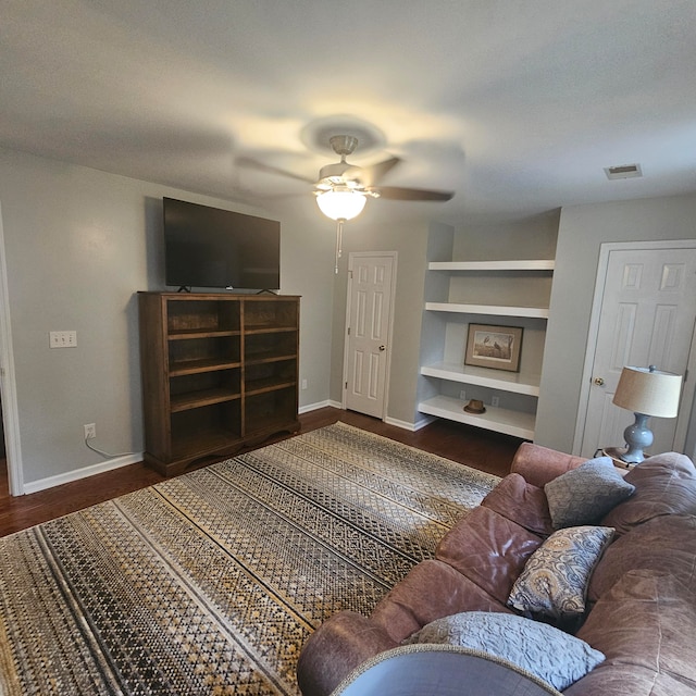 living room with ceiling fan, hardwood / wood-style flooring, and built in features