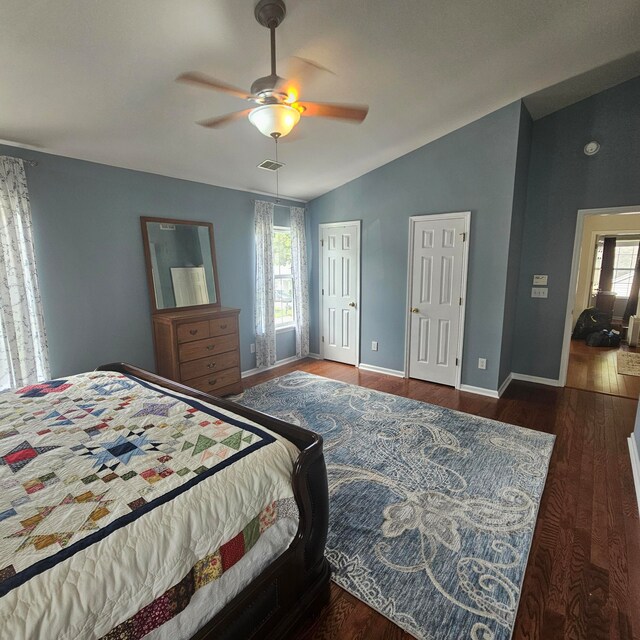 bedroom with vaulted ceiling, ceiling fan, and dark hardwood / wood-style floors