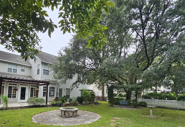 view of yard with a pergola and a fire pit