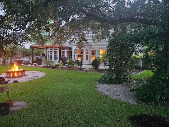 view of yard featuring a pergola and an outdoor fire pit