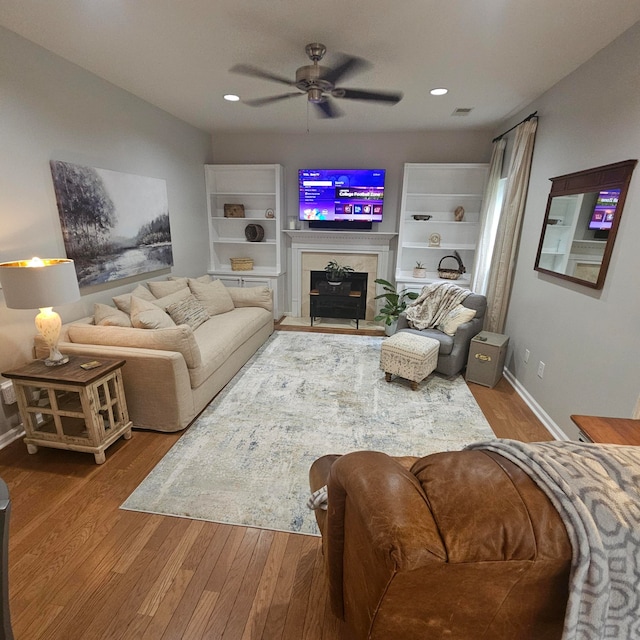 living room with ceiling fan and hardwood / wood-style floors