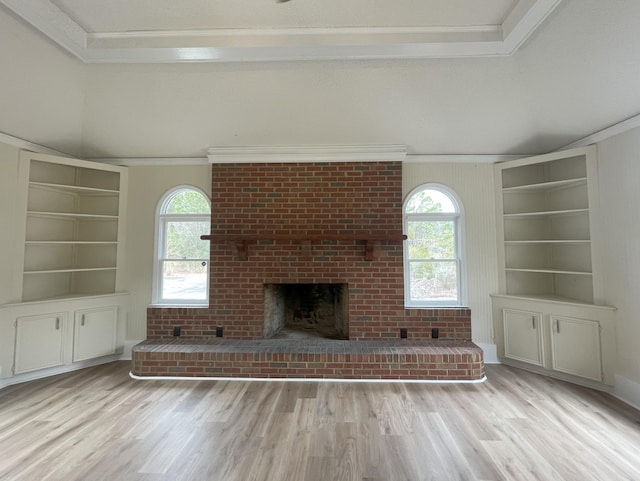 unfurnished living room featuring ornamental molding, a fireplace, and wood finished floors