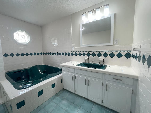 full bathroom with tile walls, tile patterned flooring, a textured ceiling, and vanity