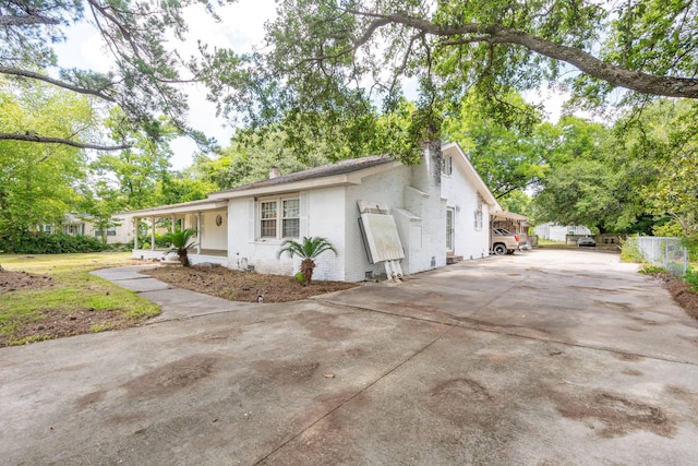 view of side of home with covered porch