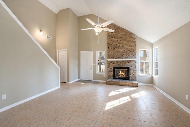 unfurnished living room featuring ceiling fan, high vaulted ceiling, light tile patterned flooring, and a brick fireplace