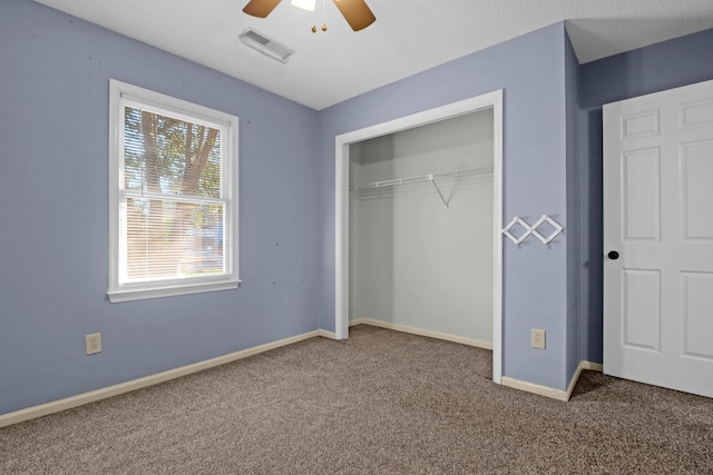 unfurnished bedroom with carpet, a closet, and ceiling fan