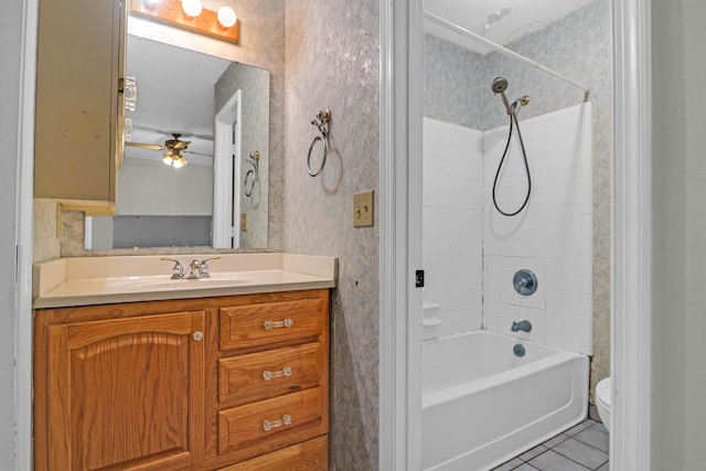 full bathroom with vanity, tiled shower / bath combo, tile patterned floors, and toilet