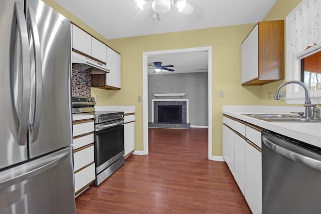 kitchen featuring dark hardwood / wood-style floors, white cabinetry, sink, and appliances with stainless steel finishes