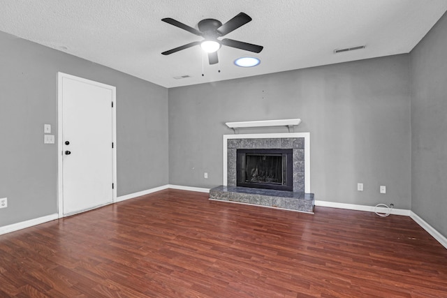 unfurnished living room with ceiling fan, a textured ceiling, and hardwood / wood-style flooring