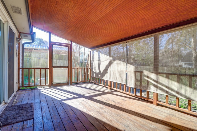 unfurnished sunroom featuring wood ceiling and vaulted ceiling