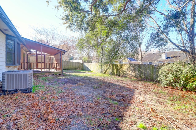 view of yard with cooling unit and a sunroom