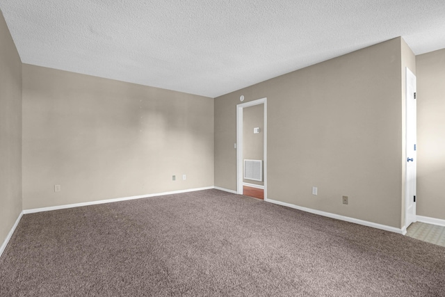 unfurnished room featuring carpet floors and a textured ceiling