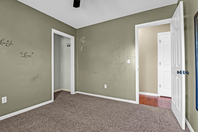 unfurnished bedroom featuring carpet floors and ceiling fan