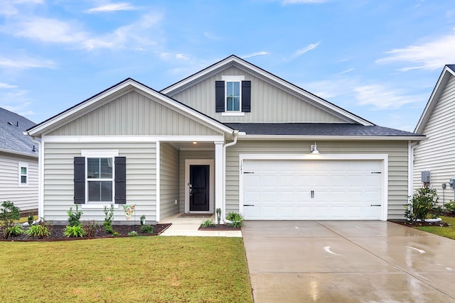 view of front of home with a front yard and a garage