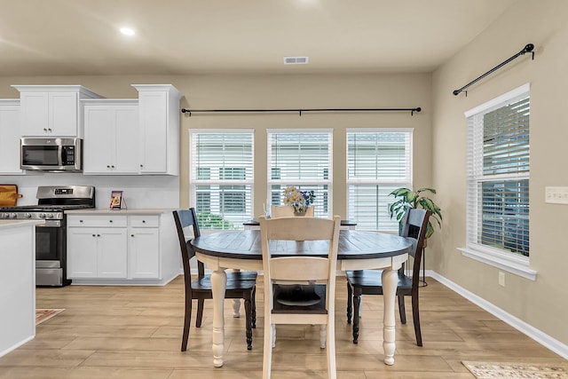 dining area with light hardwood / wood-style floors