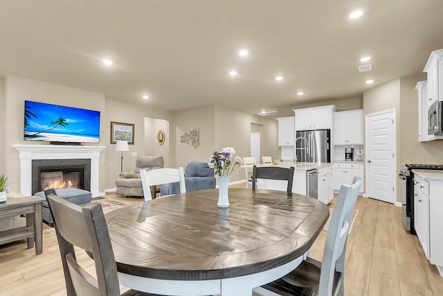 dining space with light hardwood / wood-style flooring