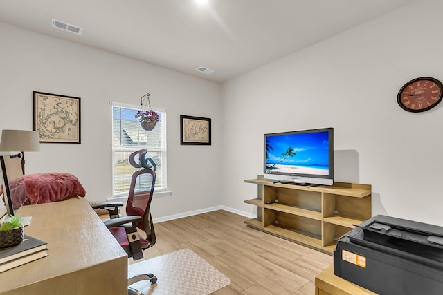 office space with light hardwood / wood-style floors