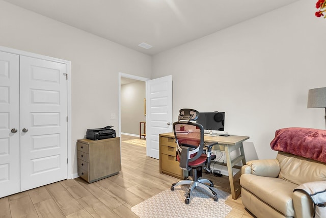 office with light hardwood / wood-style flooring