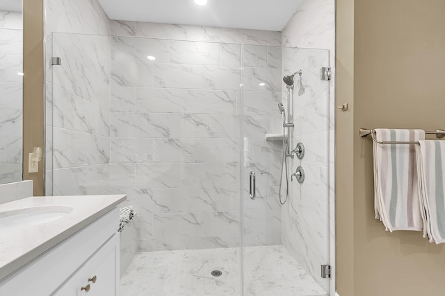 bathroom featuring walk in shower and vanity